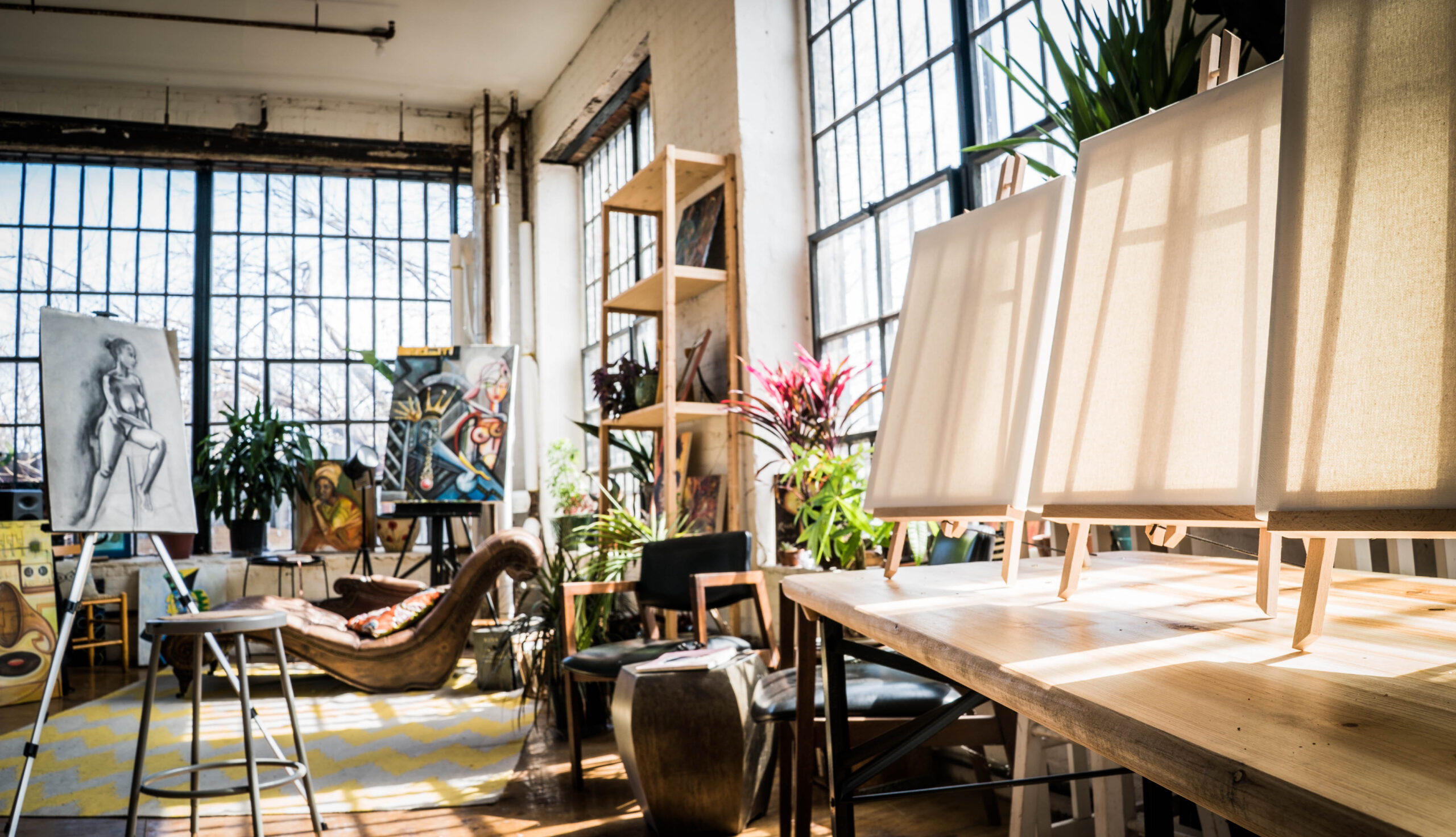 Gorgeous sunny art studio with two walls of industrial windows