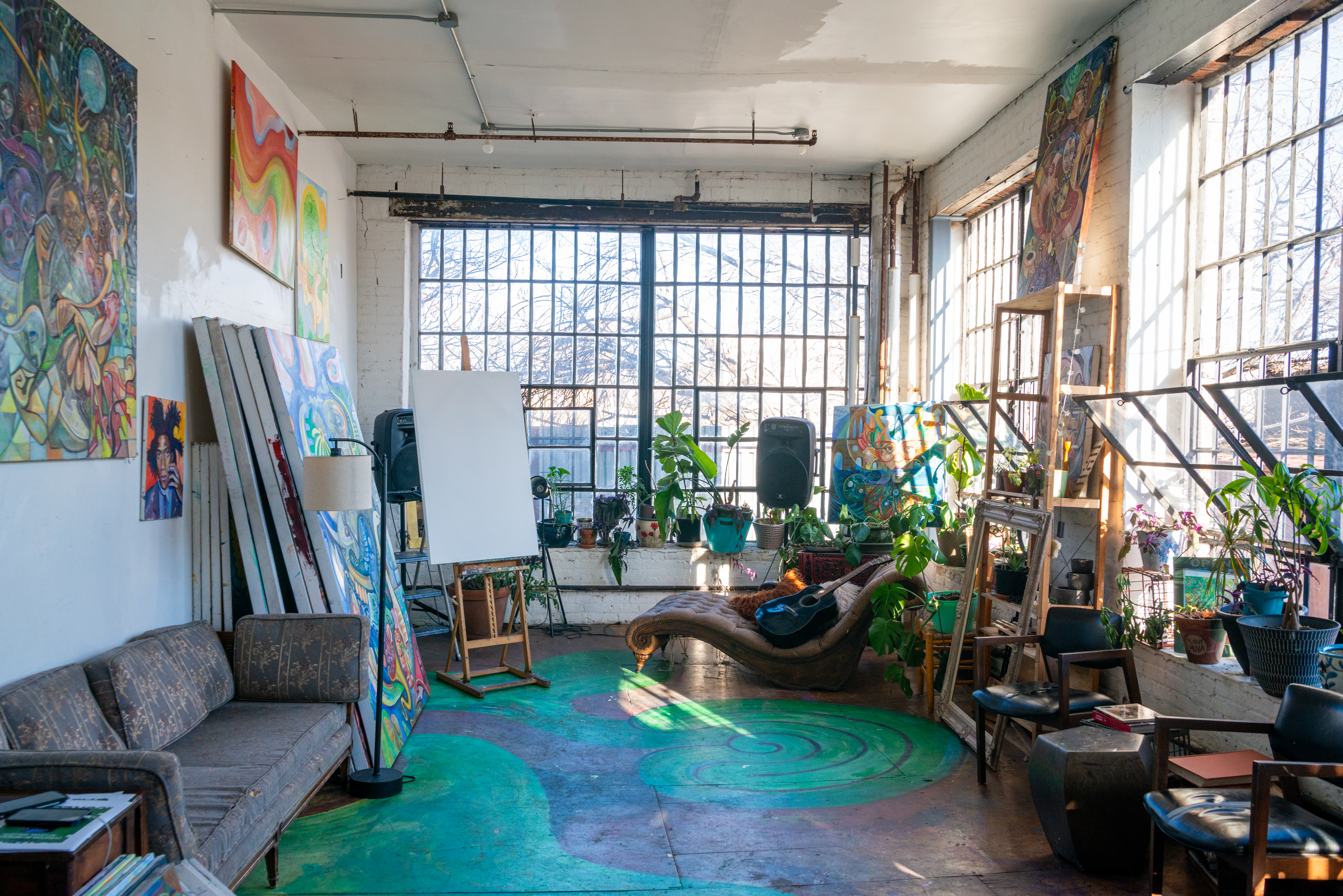 Gorgeous sunny art studio with two walls of industrial windows